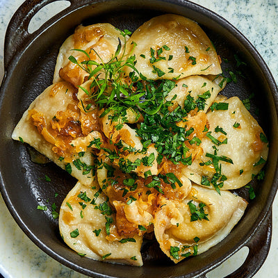 Spiced Beef and Cabbage Pierogi with Caramelized Onions and Sour Cream
