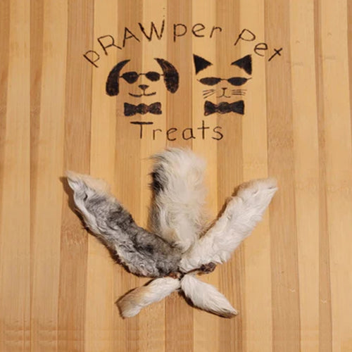 Pet treat shaped like a leaf on a wooden background with 'RAWper Pet Treats' branding.